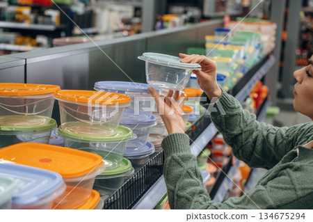 Food trays. Woman is in the hardware store, shopping conception Food trays. Woman is in the hardware store, shopping conception 134675294