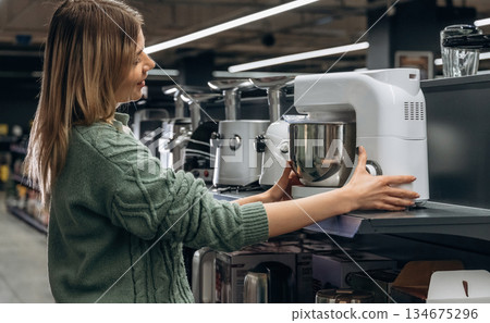 Kitchen stuff. Woman is in the hardware store, shopping conception 134675296