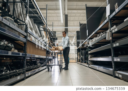 Male hardware store worker in indoors Male hardware store worker in indoors 134675339