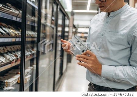 Heart of a lock in hands. Detailed close up view of man's hand in the hardware store 134675382