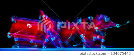 Hockey player motion composition with neon light trails on dark background Hockey player motion composition with neon light trails on dark background 134675443