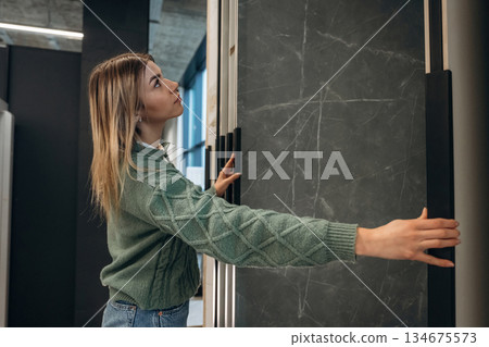 Searching for perfect plate for kitchen. Woman is in the hardware store, shopping conception 134675573