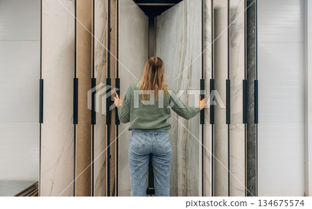 Searching for perfect plate for kitchen. Woman is in the hardware store, shopping conception 134675574