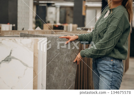 Close up view of woman that is in the hardware store Close up view of woman that is in the hardware store 134675578