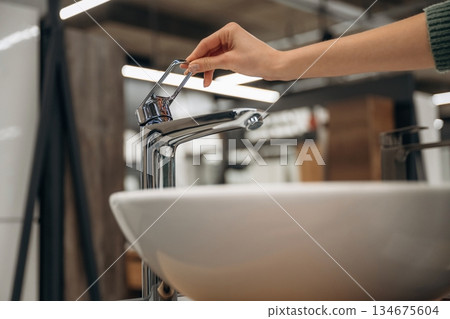 White sink. Close up view of woman that is in the hardware store White sink. Close up view of woman that is in the hardware store 134675604