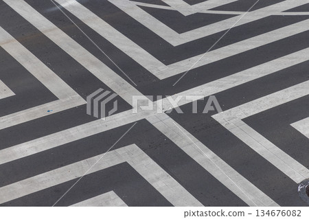 The shape created by white lines on the road The shape created by white lines on the road 134676082