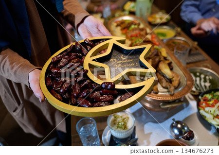 Gathering of family for iftar with dates and traditional food during Ramadan celebration Gathering of family for iftar with dates and traditional food during Ramadan celebration 134676273
