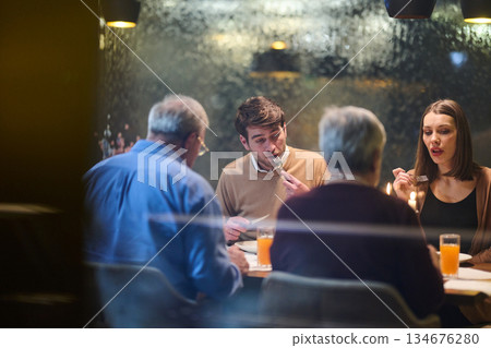 Gathering for iftar during Ramadan with family sharing moments at the table in a cozy setting 134676280
