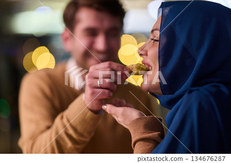 Couple sharing iftar during Ramadan with family and friends in a lively gathering at home Couple sharing iftar during Ramadan with family and friends in a lively gathering at home 134676287