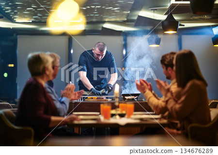 Gathering around the table for iftar meal during Ramadan with family and friends in a modern restaurant setting Gathering around the table for iftar meal during Ramadan with family and friends in a modern restaurant setting 134676289