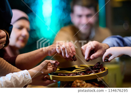Families gather and share dates for iftar during Ramadan at home with a warm atmosphere and joyful spirit of tradition Families gather and share dates for iftar during Ramadan at home with a warm atmosphere and joyful spirit of tradition 134676295