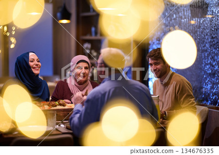 Gathering for iftar with family during Ramadan reflecting traditions and togetherness in a warm atmosphere Gathering for iftar with family during Ramadan reflecting traditions and togetherness in a warm atmosphere 134676335