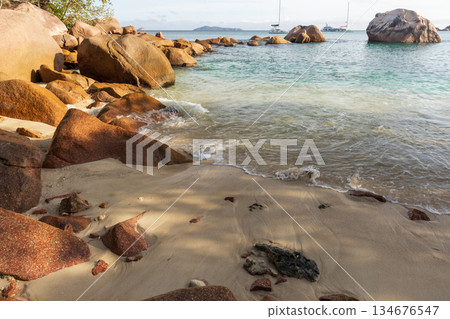 Anse Lazio beach, Praslin island, Seychelles. A rocky shoreline frames a sunny beach Anse Lazio beach, Praslin island, Seychelles. A rocky shoreline frames a sunny beach 134676547
