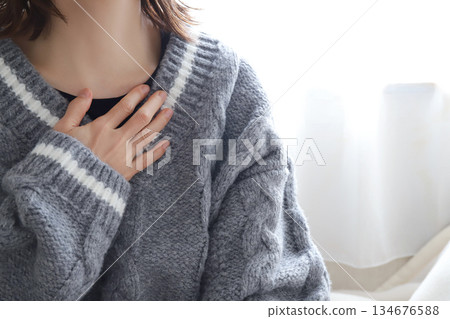 Woman holding her chest: Anxiety, worry Woman holding her chest: Anxiety, worry 134676588