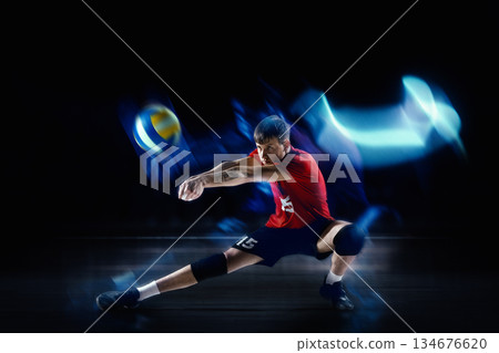 Expressive mixed media with volleyball player receiving the ball in defensive stance with motion blur. 134676620