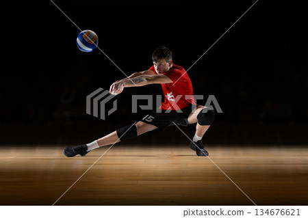 Modern mixed media shows volleyball player receiving the ball in low defensive stance. Modern mixed media shows volleyball player receiving the ball in low defensive stance. 134676621