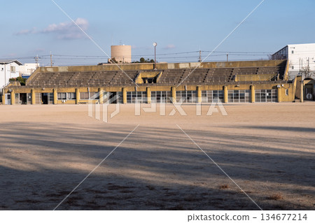 The dilapidated concrete stands and long winter shadows of the Civic Sports Park in Matsubara City, Osaka Prefecture The dilapidated concrete stands and long winter shadows of the Civic Sports Park in Matsubara City, Osaka Prefecture 134677214