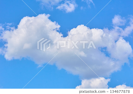 Large cheerful white cloud in blue sky. Awesome atmosphere 134677878