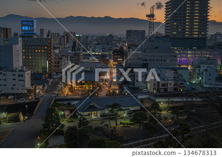 View of Koedo Kofu Hanakoji and Kofu city at dusk from Maizuru Castle Park [Kofu City, Yamanashi Prefecture] 134678313
