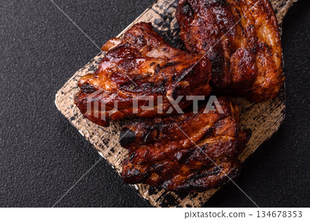 Grilled or barbecued pork ribs with sauce. Grilled ribs 134678353
