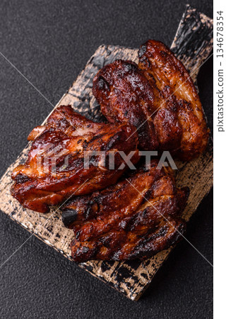 Grilled or barbecued pork ribs with sauce. Grilled ribs 134678354