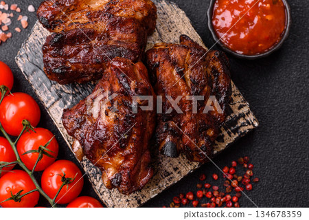 Grilled or barbecued pork ribs with sauce. Grilled ribs 134678359
