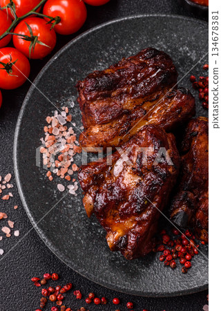 Grilled or barbecued pork ribs with sauce. Grilled ribs 134678381