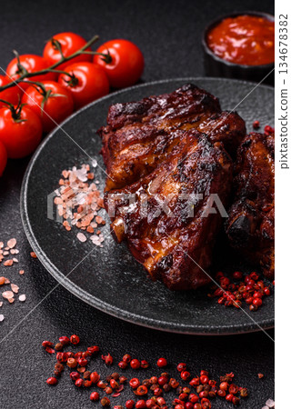 Grilled or barbecued pork ribs with sauce. Grilled ribs 134678382