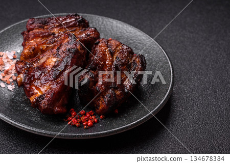 Grilled or barbecued pork ribs with sauce. Grilled ribs 134678384