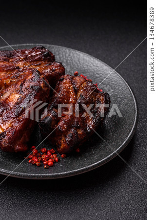 Grilled or barbecued pork ribs with sauce. Grilled ribs 134678389