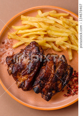 Grilled or barbecued pork ribs with sauce. Grilled ribs Grilled or barbecued pork ribs with sauce. Grilled ribs 134678407