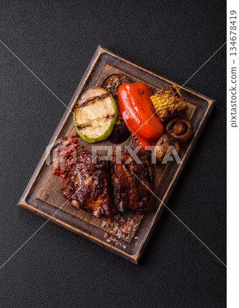 Grilled or barbecued pork ribs with sauce. Grilled ribs 134678419