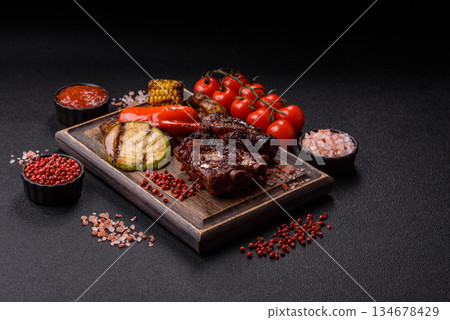 Grilled or barbecued pork ribs with sauce. Grilled ribs 134678429