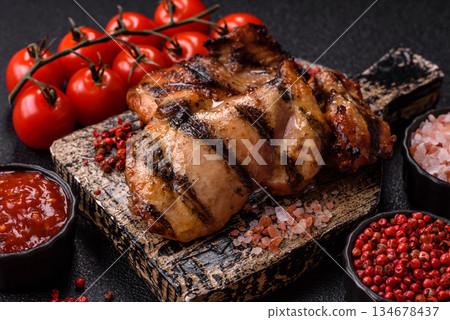 Chicken breast cooked on a grill or barbecue with sauce. Grilled chicken 134678437