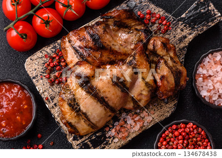 Chicken breast cooked on a grill or barbecue with sauce. Grilled chicken 134678438