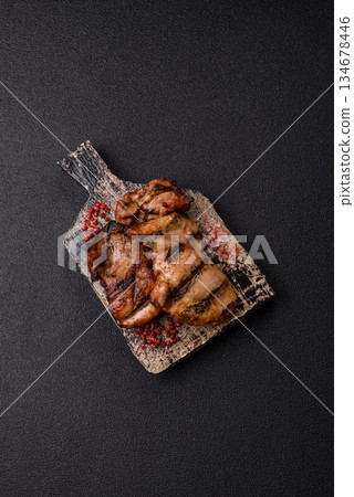 Chicken breast cooked on a grill or barbecue with sauce. Grilled chicken 134678446