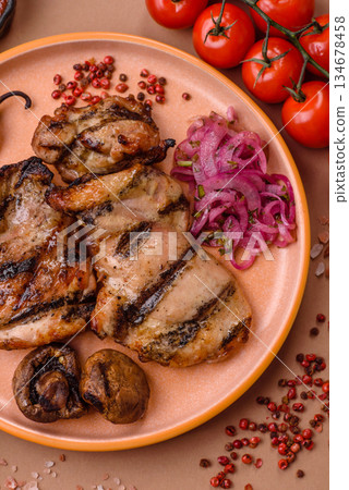 Chicken breast cooked on a grill or barbecue with sauce. Grilled chicken Chicken breast cooked on a grill or barbecue with sauce. Grilled chicken 134678458