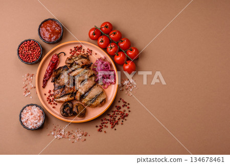 Chicken breast cooked on a grill or barbecue with sauce. Grilled chicken 134678461