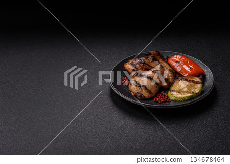 Chicken breast cooked on a grill or barbecue with sauce. Grilled chicken Chicken breast cooked on a grill or barbecue with sauce. Grilled chicken 134678464