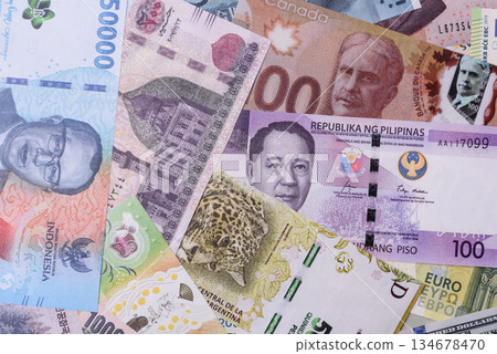 Paper money, banknotes of different countries as a business background. Paper money and cash Paper money, banknotes of different countries as a business background. Paper money and cash 134678470