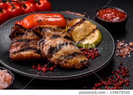 Chicken breast cooked on a grill or barbecue with sauce. Grilled chicken Chicken breast cooked on a grill or barbecue with sauce. Grilled chicken 134678500