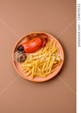 French fries cooked in oil, crispy golden chips, unhealthy food. French fries as a background French fries cooked in oil, crispy golden chips, unhealthy food. French fries as a background 134678552