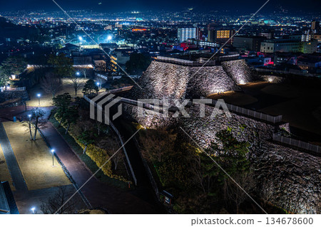 Illuminated stone walls of Kofu Castle and the glittering night view of the city [Kofu City, Yamanashi Prefecture] 134678600