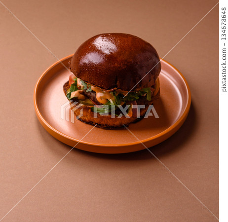 A burger, a hamburger with cheese, beef, and a bun, is unhealthy takeaway food. A burger A burger, a hamburger with cheese, beef, and a bun, is unhealthy takeaway food. A burger 134678648