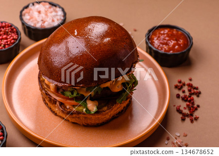 A burger, a hamburger with cheese, beef, and a bun, is unhealthy takeaway food. A burger 134678652
