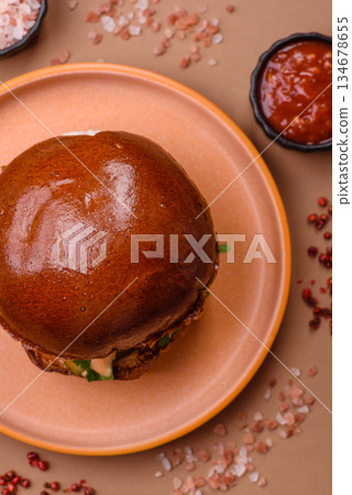 A burger, a hamburger with cheese, beef, and a bun, is unhealthy takeaway food. A burger A burger, a hamburger with cheese, beef, and a bun, is unhealthy takeaway food. A burger 134678655