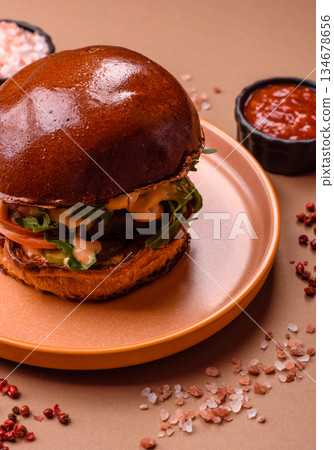 A burger, a hamburger with cheese, beef, and a bun, is unhealthy takeaway food. A burger 134678656