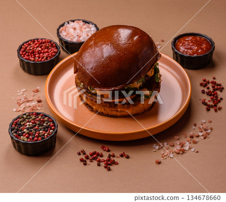 A burger, a hamburger with cheese, beef, and a bun, is unhealthy takeaway food. A burger 134678660