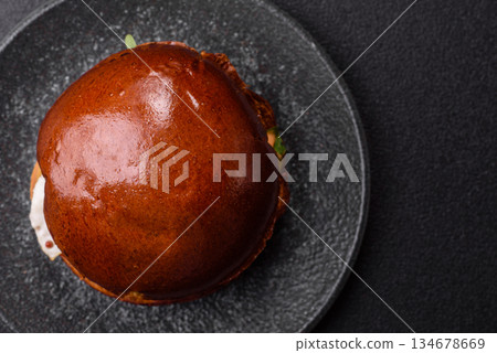 A burger, a hamburger with cheese, beef, and a bun, is unhealthy takeaway food. A burger A burger, a hamburger with cheese, beef, and a bun, is unhealthy takeaway food. A burger 134678669