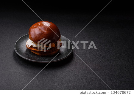 A burger, a hamburger with cheese, beef, and a bun, is unhealthy takeaway food. A burger A burger, a hamburger with cheese, beef, and a bun, is unhealthy takeaway food. A burger 134678672